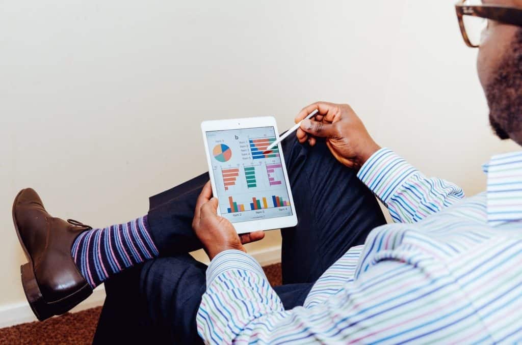 Man looking at a dashboard on a tablet.